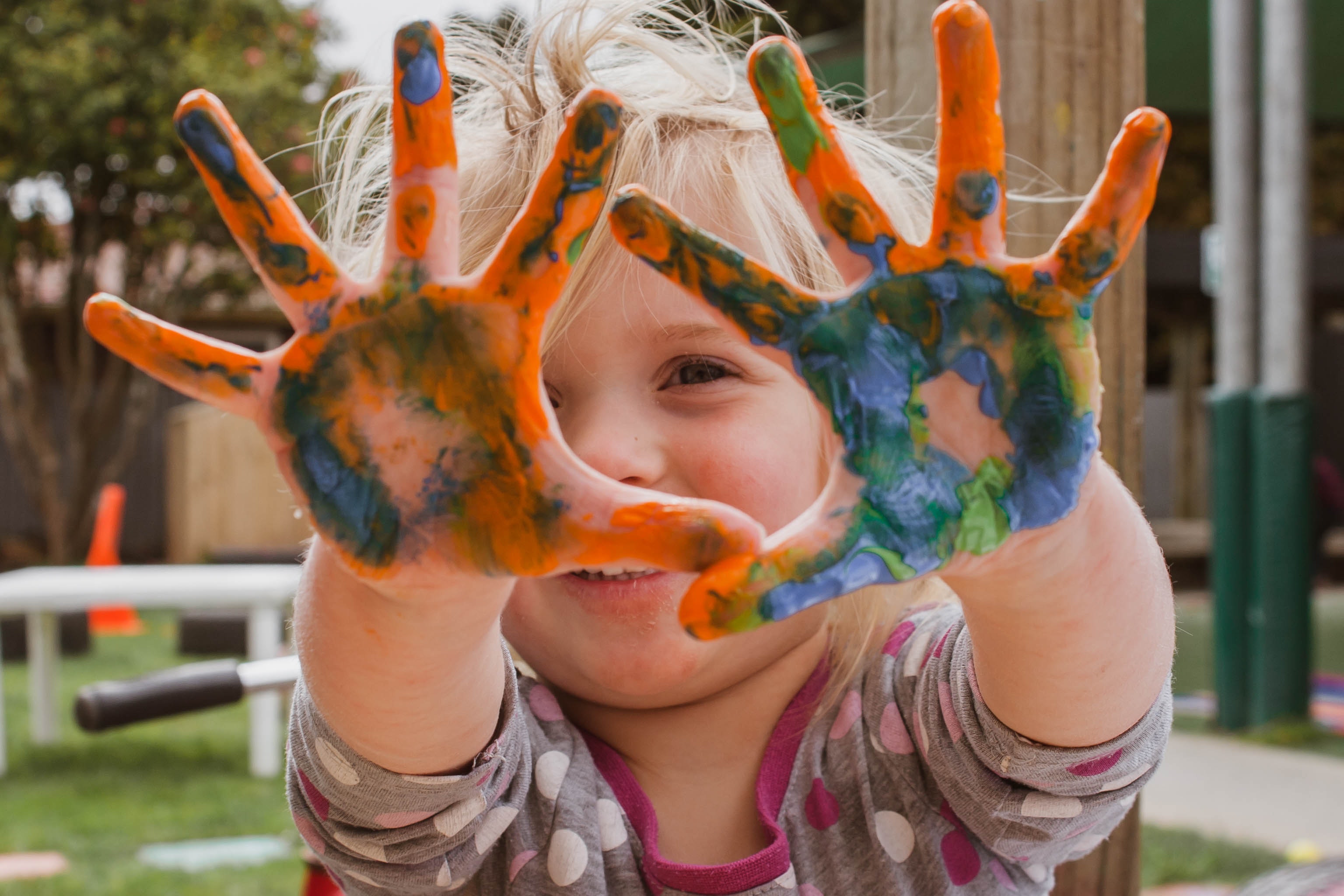 Picture of toddler with paints on her hands